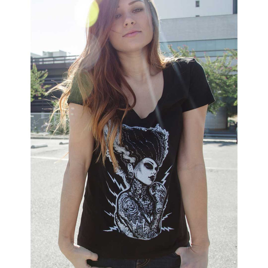 Woman wearing a black t-shirt with a graphic design outdoors