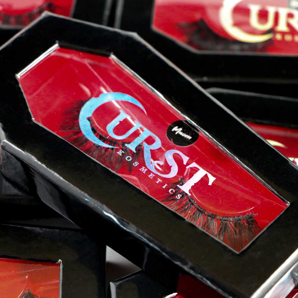 Box of Curse Cosmetics false eyelashes on a black surface