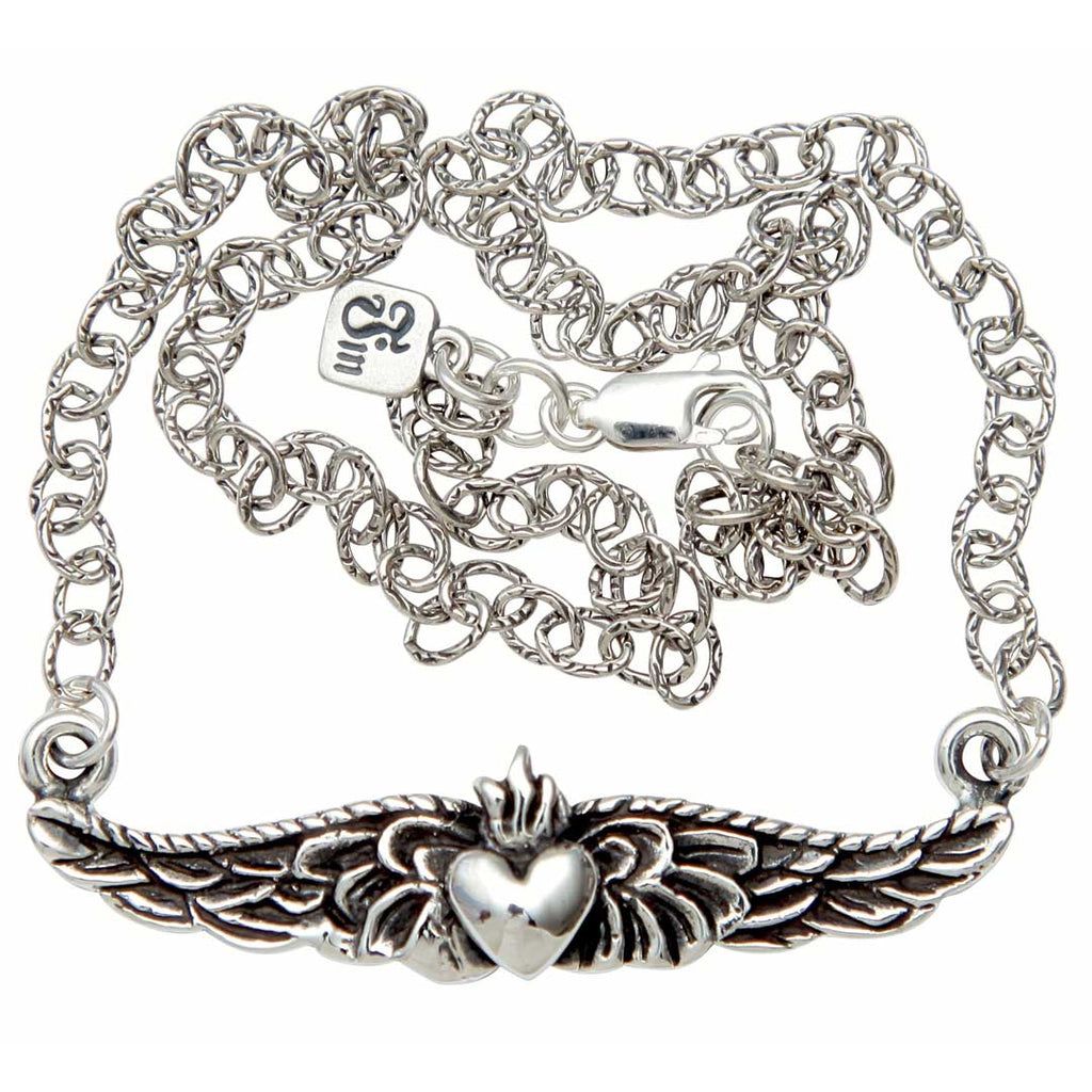 Silver bracelet with claddagh design on a white background