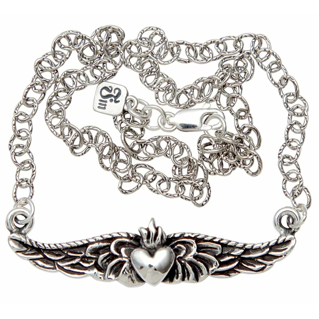 Silver bracelet with claddagh design on a white background