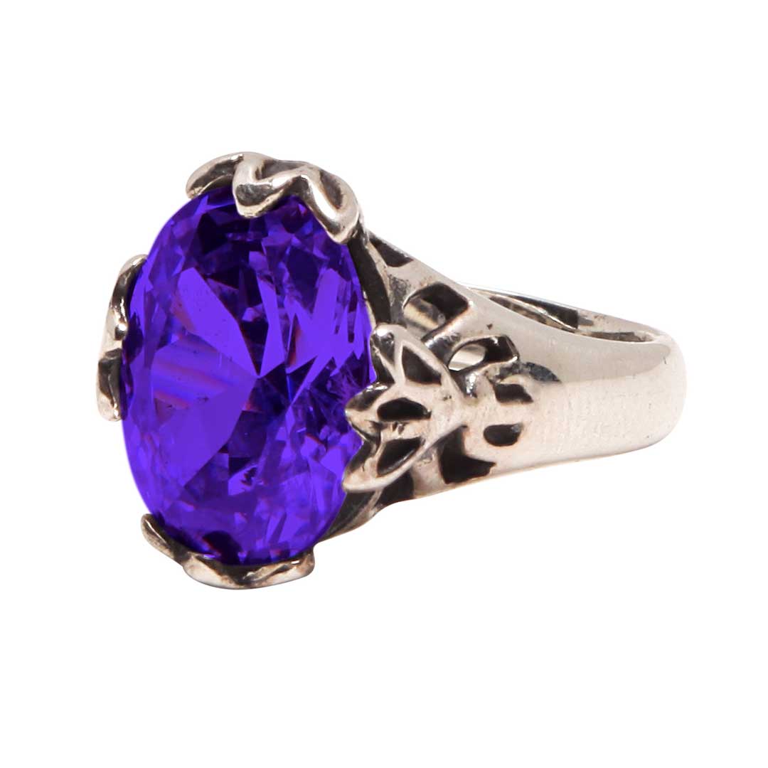 Silver ring with a purple gemstone on a white background