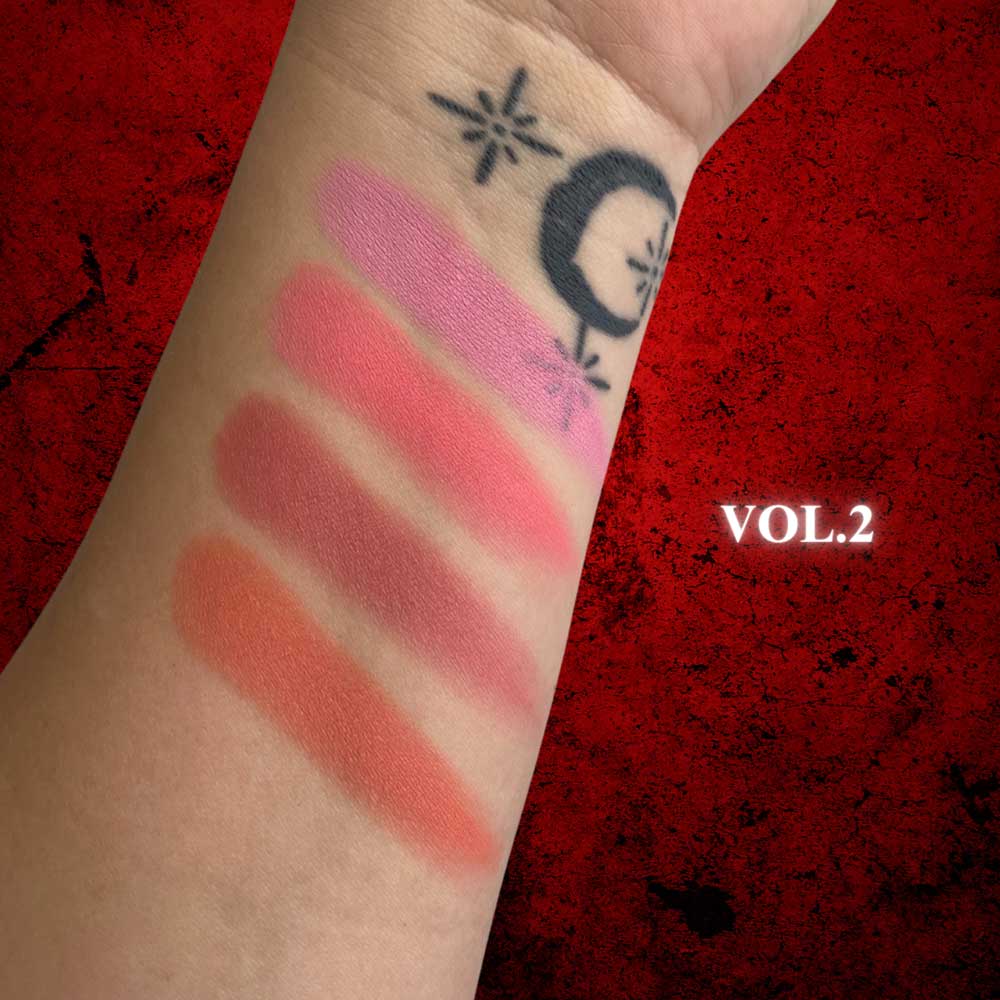 Lipstick swatches on a wrist with a red background and 'VOL.2' text.