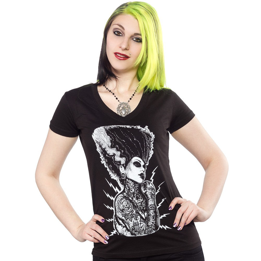 Woman wearing a black t-shirt with a graphic design on a white background