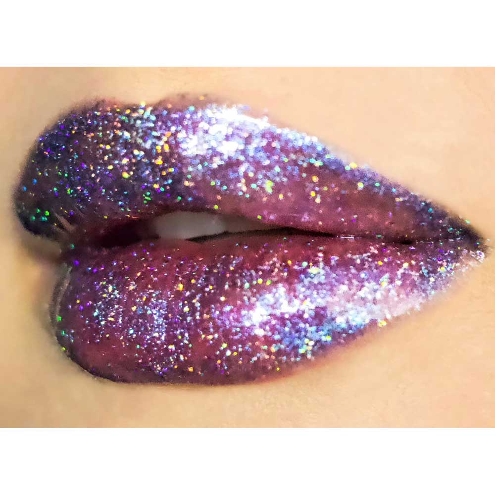Close-up of lips with glittery, multicolored lipstick on a neutral background