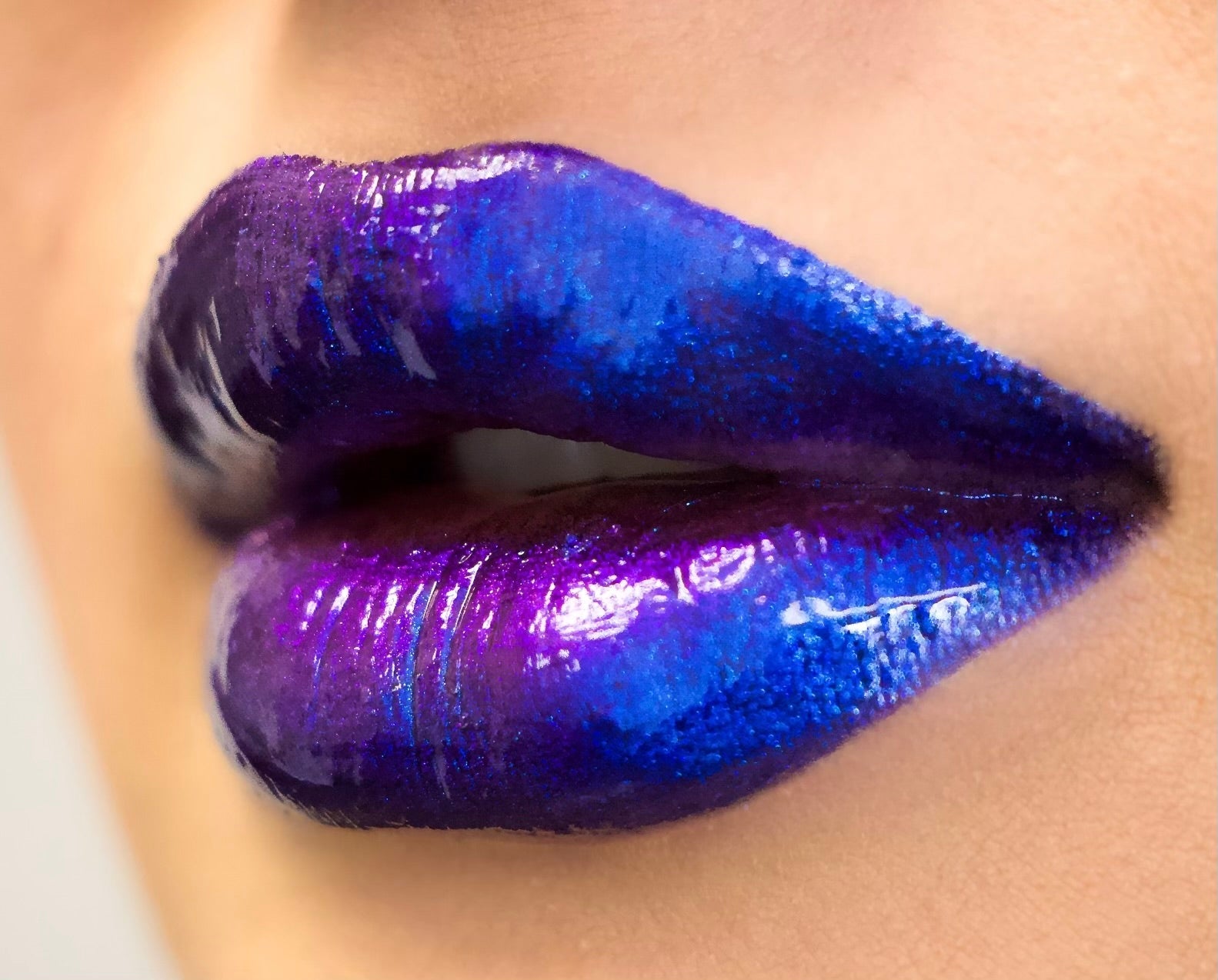 Close-up of lips with vibrant blue and purple lipstick