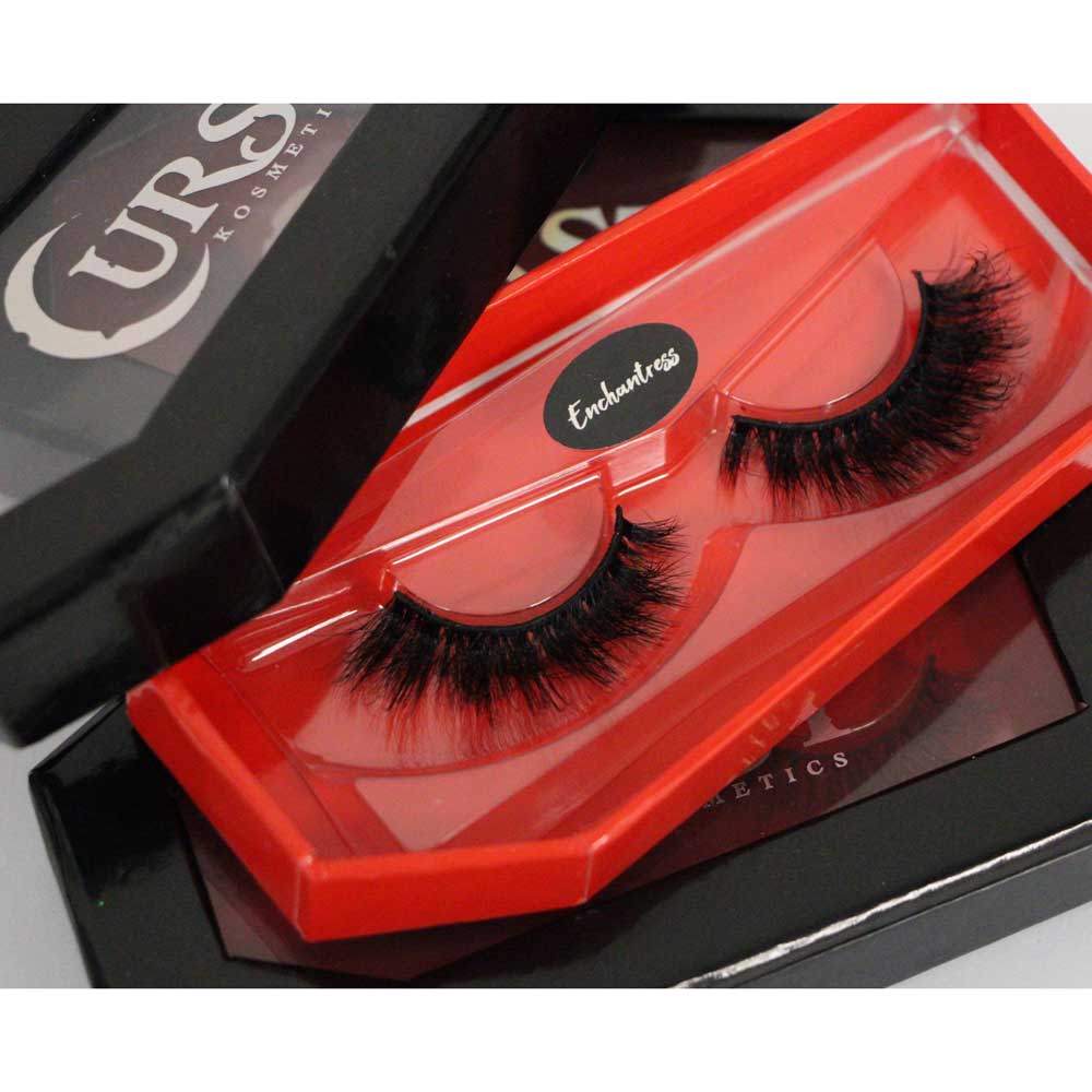 Eyelashes in a red case with a visible brand logo on a black background