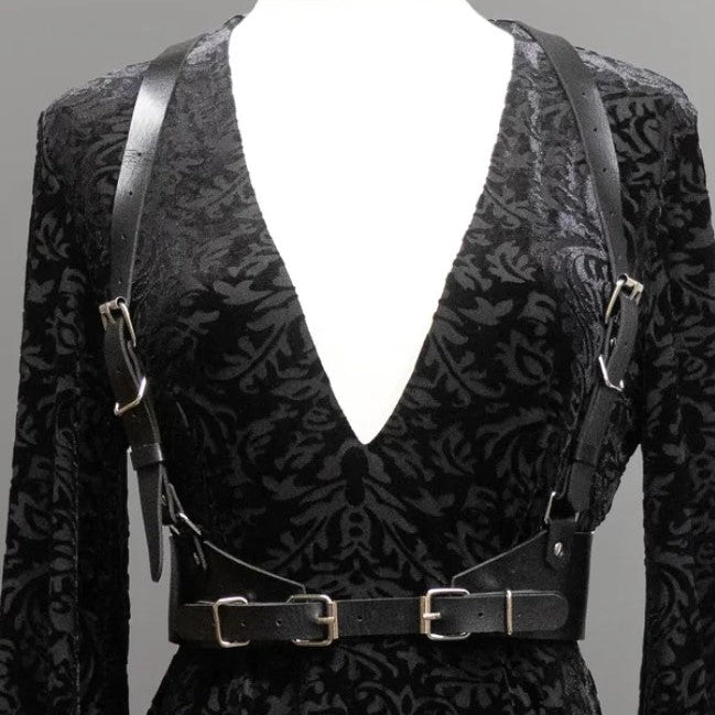 Black patterned suit with suspenders on a mannequin against a gray background