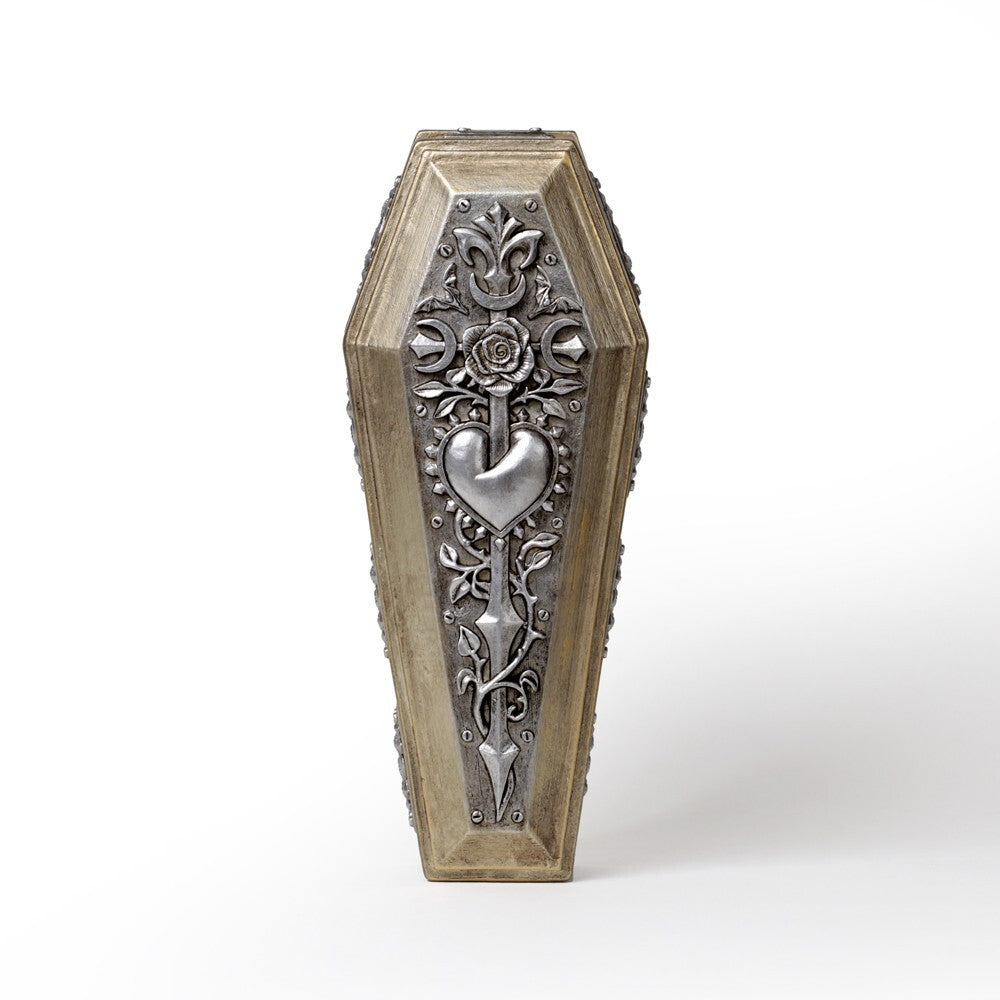 Decorative coffin-shaped object with intricate metalwork on a white background