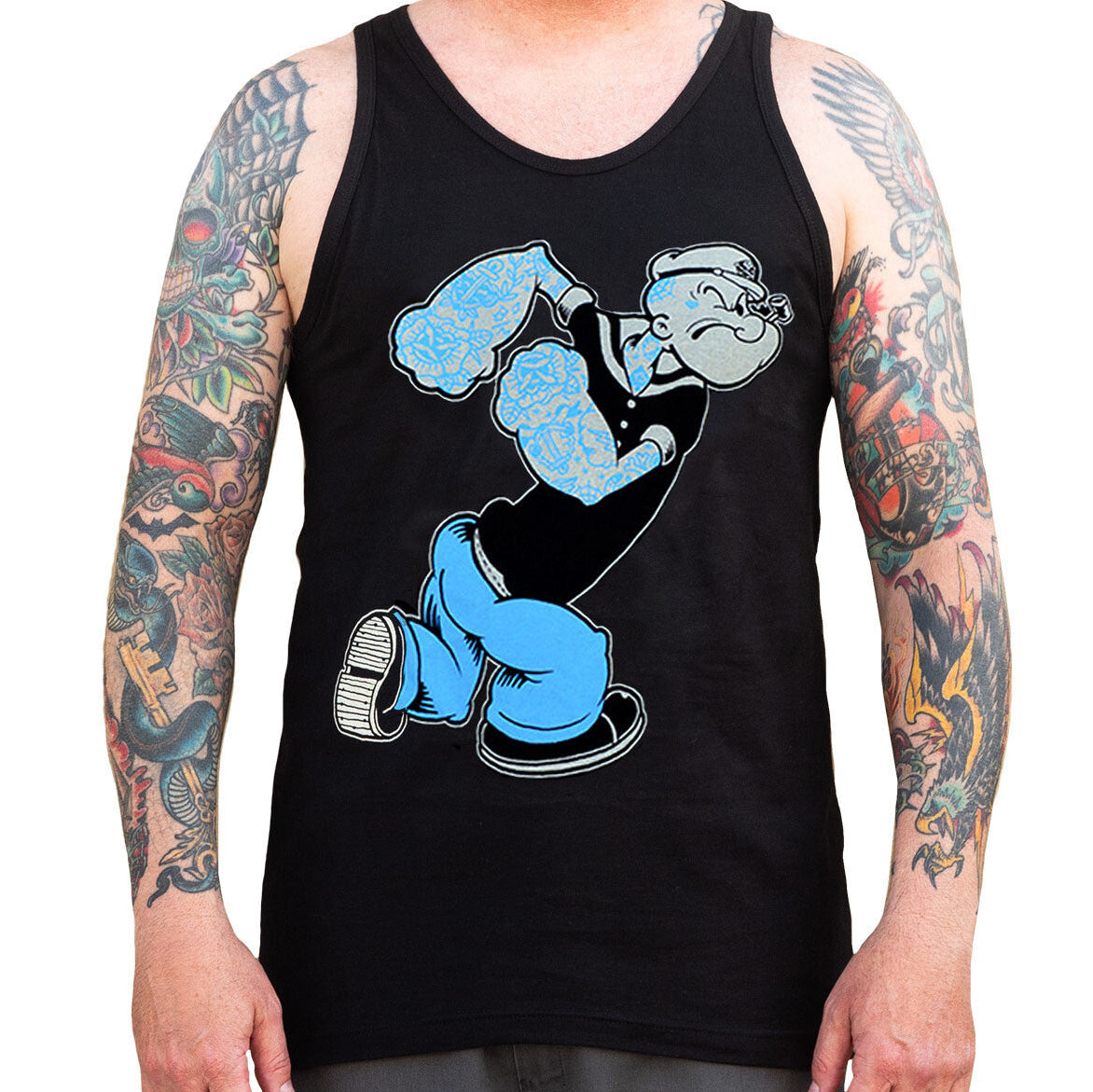 Black tank top with blue and white graphic design on a person with tattoos.