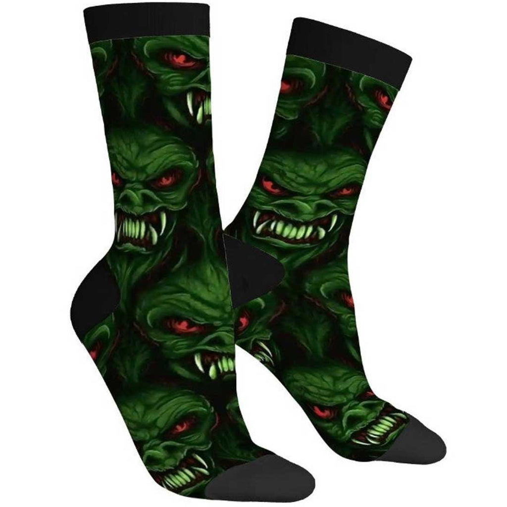 Pair of socks with green monster design on a white background