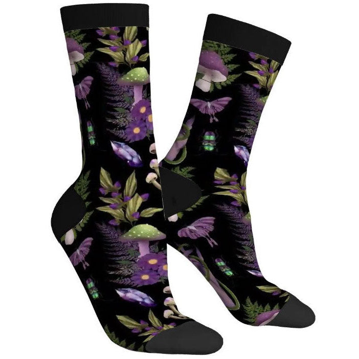 Pair of socks with a black background and colorful mushroom and leaf pattern.