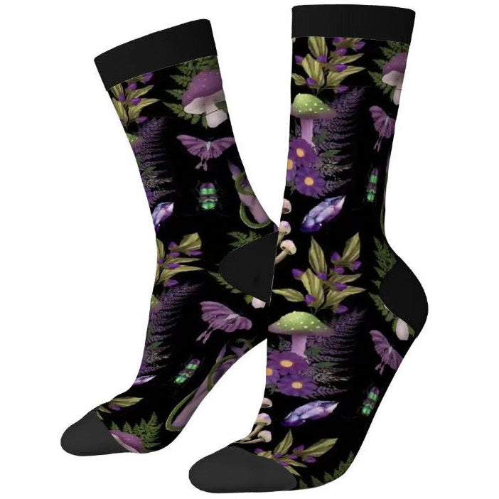 Pair of socks with a black background and colorful mushroom and leaf pattern.