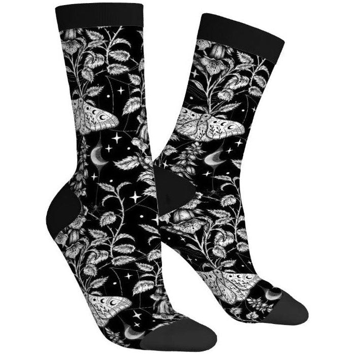 Black socks with white floral and moth pattern on a white background
