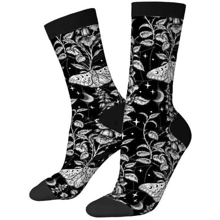 Black socks with white floral and moth pattern on a white background